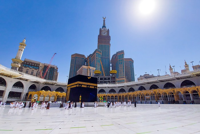 Mecca , Saudi Arabia , Oct/22/2020 - Pilgrims circle the Kaaba at Masjid al-Haram - umrah Fewer Muslims people socially distanced corona virus wearing face mask Covid 19