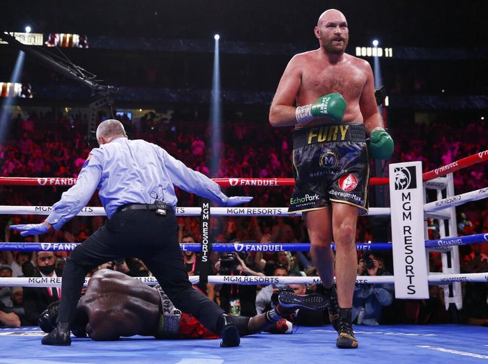 Tyson Fury, of England, knocks out Deontay Wilder to win in the 11th round in a heavyweight championship boxing match Saturday, Oct. 9, 2021, in Las Vegas. (AP Photo/Chase Stevens)