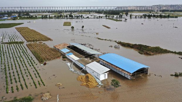 In this photo released by Xinhua News Agency, an aerial photo shows an overflowing Yellow River near the Lianbo Village in Hejin City, northern China's Shanxi Province, Sunday, Oct. 10, 2021. (Zhan Yan/Xinhua via AP)