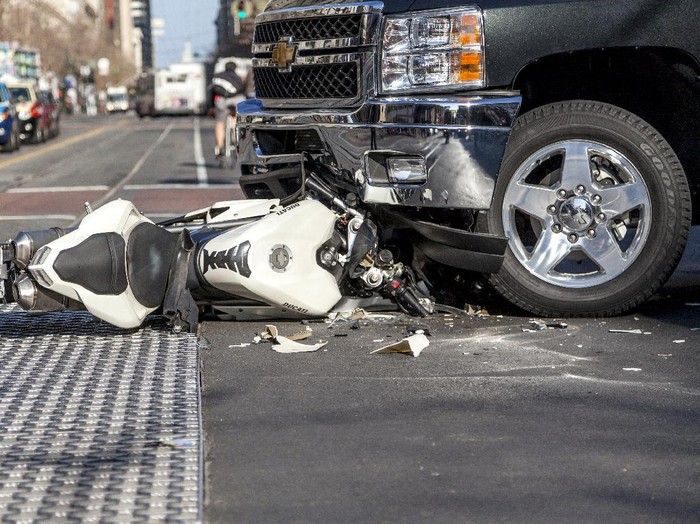 San Francisco, USA - January 23, 2014: A bad traffic accident between a white Ducati motorcycle and Chevy pickup truck occurred on Market street in the late afternoon and brought traffic to a halt, backing up Muni buses and light rain trains. No fatalities were reported.