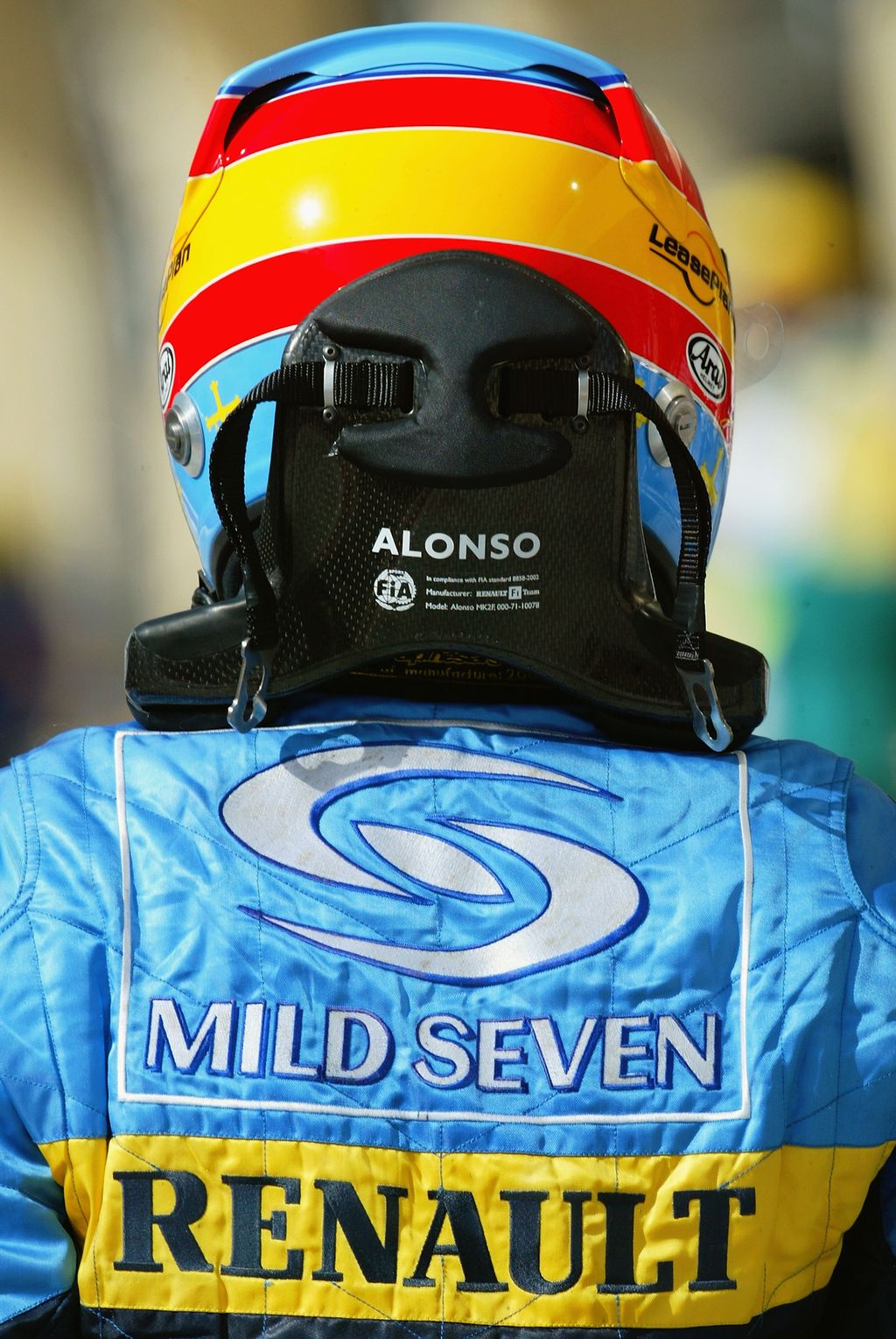 SAKHIR, BAHRAIN - APRIL 2:  Fernando Alonso of Spain and Renault wears the HANS safety device during practice for the Bahrain F1 Grand Prix at the Bahrain Racing Circuit on April 2, 2004 in Sakhir, Bahrain  (Photo by Bryn Lennon/Getty Images)