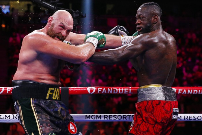 Tyson Fury, of England, left, fights Deontay Wilder in a heavyweight championship boxing match Saturday, Oct. 9, 2021, in Las Vegas. (AP Photo/Chase Stevens)