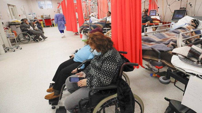 Patients lie on beds in the emergency room, turned into a CODIV-19 unit due to the high number of cases, at the Bagdasar-Arseni hospital in Bucharest, Romania, Tuesday, Oct. 12, 2021. (AP Photo/Andreea Alexandru)