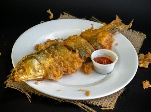 Bandeng Presto Goreng. Fried tendered-bone milkfish served with traditional side dishes