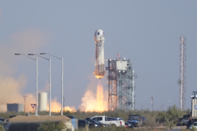 Audrey Powers, left, speaks as William Shatner, from left, Chris Boshuizen and Glen de Vries look on during a media availability at the Blue Origin spaceport near Van Horn, Texas, Wednesday, Oct. 13, 2021.  The “Star Trek” actor and the three fellow passengers hurtled to an altitude of 66.5 miles (107 kilometers) over the West Texas desert in the fully automated capsule, then safely parachuted back to Earth in a flight that lasted just over 10 minutes. (AP Photo/LM Otero)