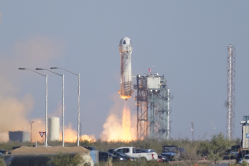 Audrey Powers, left, speaks as William Shatner, from left, Chris Boshuizen and Glen de Vries look on during a media availability at the Blue Origin spaceport near Van Horn, Texas, Wednesday, Oct. 13, 2021.  The “Star Trek” actor and the three fellow passengers hurtled to an altitude of 66.5 miles (107 kilometers) over the West Texas desert in the fully automated capsule, then safely parachuted back to Earth in a flight that lasted just over 10 minutes. (AP Photo/LM Otero)