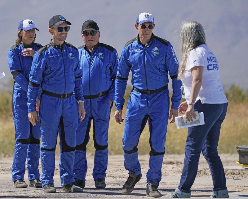 Audrey Powers, left, speaks as William Shatner, from left, Chris Boshuizen and Glen de Vries look on during a media availability at the Blue Origin spaceport near Van Horn, Texas, Wednesday, Oct. 13, 2021.  The “Star Trek” actor and the three fellow passengers hurtled to an altitude of 66.5 miles (107 kilometers) over the West Texas desert in the fully automated capsule, then safely parachuted back to Earth in a flight that lasted just over 10 minutes. (AP Photo/LM Otero)