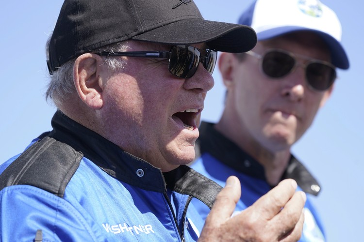 Audrey Powers, left, speaks as William Shatner, from left, Chris Boshuizen and Glen de Vries look on during a media availability at the Blue Origin spaceport near Van Horn, Texas, Wednesday, Oct. 13, 2021.  The “Star Trek” actor and the three fellow passengers hurtled to an altitude of 66.5 miles (107 kilometers) over the West Texas desert in the fully automated capsule, then safely parachuted back to Earth in a flight that lasted just over 10 minutes. (AP Photo/LM Otero)