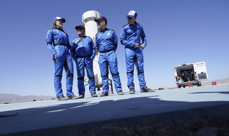 Audrey Powers, left, speaks as William Shatner, from left, Chris Boshuizen and Glen de Vries look on during a media availability at the Blue Origin spaceport near Van Horn, Texas, Wednesday, Oct. 13, 2021.  The “Star Trek” actor and the three fellow passengers hurtled to an altitude of 66.5 miles (107 kilometers) over the West Texas desert in the fully automated capsule, then safely parachuted back to Earth in a flight that lasted just over 10 minutes. (AP Photo/LM Otero)