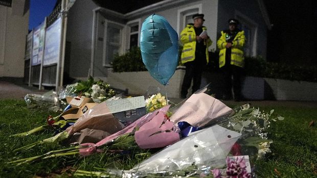 Floral tributes are placed on one of the roads leading to the Belfairs Methodist Church in Eastwood Road North, where British Conservative lawmaker David Amess has died after being stabbed at a constituency surgery, in Leigh-on-Sea, Essex, England, Friday, Oct. 15, 2021. Police gave no immediate details on the motive for the killing of 69-year-old Conservative lawmaker Amess and did not identify the suspect, who was being held on suspicion of murder. (AP Photo/Kirsty Wigglesworth)