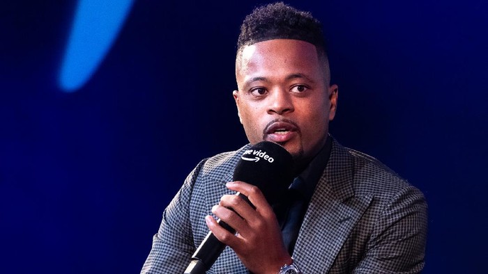 LONDON, ENGLAND - OCTOBER 12: Patrice Evra speaking with Gabby Logan on stage at the Prime Video Presents Sport event at Pan Pacific on October 12, 2021 in London, England.  At the event a series of announcements were revealed, including the Amazon Original documentary on the life and career of Wayne Rooney and Lioness: The Nicola Adams Story.  (Photo by Tim P. Whitby/Getty Images for Amazon Prime)