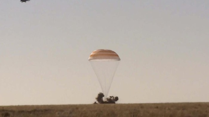In this photo taken from video footage released by Roscosmos Space Agency, Russian space agency rescue team members help film director Klim Shipenko out from the capsule shortly after the landing of the Russian Soyuz MS-18 space capsule, southeast of the Kazakh town of Zhezkazgan, Kazakhstan, Sunday, Oct. 17, 2021. The Soyuz MS-18 capsule landed upright in the steppes of Kazakhstan on Sunday with cosmonaut Oleg Novitskiy, actress Yulia Peresild and film director Klim Shipenko aboard after a 3 1/2-hour trip from the International Space Station. (Roscosmos Space Agency via AP)