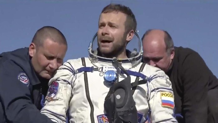 In this photo taken from video footage released by Roscosmos Space Agency, Russian space agency rescue team members help film director Klim Shipenko out from the capsule shortly after the landing of the Russian Soyuz MS-18 space capsule, southeast of the Kazakh town of Zhezkazgan, Kazakhstan, Sunday, Oct. 17, 2021. The Soyuz MS-18 capsule landed upright in the steppes of Kazakhstan on Sunday with cosmonaut Oleg Novitskiy, actress Yulia Peresild and film director Klim Shipenko aboard after a 3 1/2-hour trip from the International Space Station. (Roscosmos Space Agency via AP)