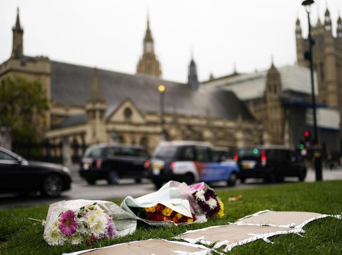 Flowers are placed as a tribute in Parliament Square following Fridays death of member of Parliament David Amess in Leigh-on-Sea, Essex, in London, Saturday, Oct. 16, 2021. Leaders from across the political spectrum came together Saturday to pay tribute to a long-serving British lawmaker who was stabbed to death in what police have described as a terrorist incident. (Aaron Chown/PA via AP)