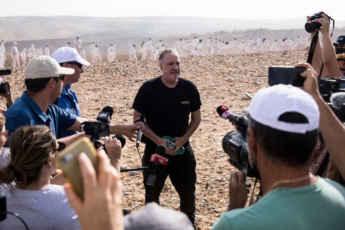 ARAD, ISRAEL - OCTOBER 17: (FOR EDITORIAL USE ONLY) American artist Spencer Tunick prepares for photographing as Tunick's photo installation is unveiled on October 17, 2021 in Arad, Israel.  Around 300 participants took part in the nude photo installation which Tunick designed to highlight the importance of preserving and restoring the Dead Sea in mind.  (Photo by Amir Levy/Getty Images)