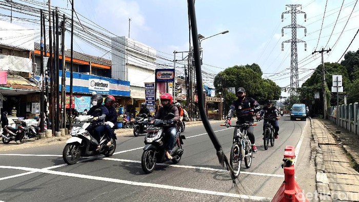 Bahaya, Kabel Dibiarkan Menjuntai di Depok Kabel menjuntai rendah di Jalan Nusantara Raya, Depok, Selasa (19/10/2021), dinilai membahayakan bagi warga yang melintas.