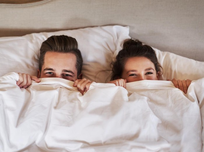 Shot of an affectionate young couple spending some quality time together in their bedroom at home