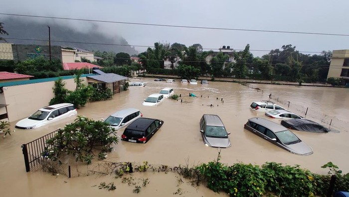 Submerged cars are seen at a flooded hotel resort as extreme rainfall caused the Kosi River to overflow at the Jim Corbett National Park in Uttarakhand, India, Tuesday, Oct. 19, 2021. More than 20 people have died and many are missing in floods triggered by heavy rains in the northern Indian state of Uttarakhand, officials said Tuesday. (AP Photo/Mustafa Quraishi)