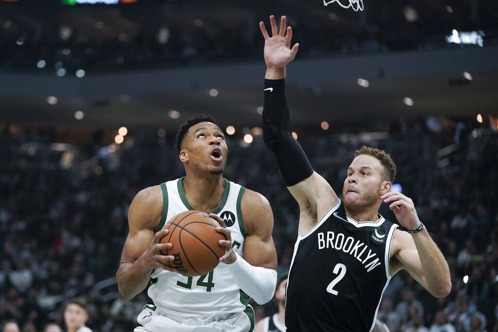 Milwaukee Bucks' Giannis Antetokounmpo (34) looks for a shot next to Brooklyn Nets' Blake Griffin (2) during the first half of an NBA basketball game Tuesday, Oct. 19, 2021, in Milwaukee. (AP Photo/Morry Gash)