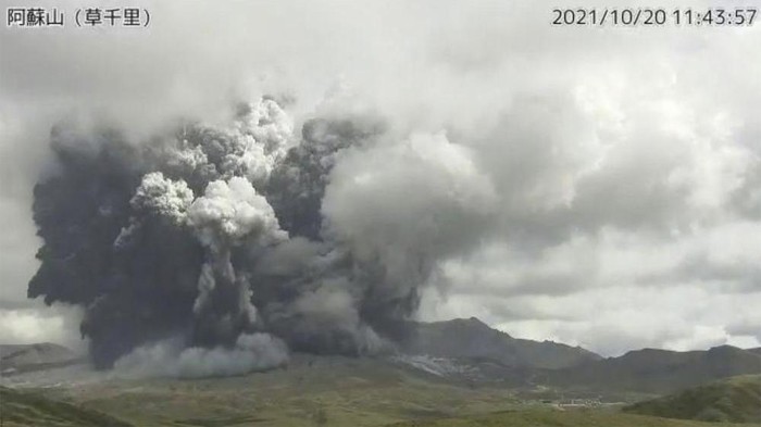 In this image taken by a surveillance camera released by Japan Meteorological Agency, smokes rise from the No. 1 Nakadake crater of Mr. Aso after its eruption, observed from Kusasenri, southwestern Japan, Wednesday, Oct. 20, 2021. The eruption occurred at 11:43 a.m., according to the agency. (Japan Meteorological Agency via AP)