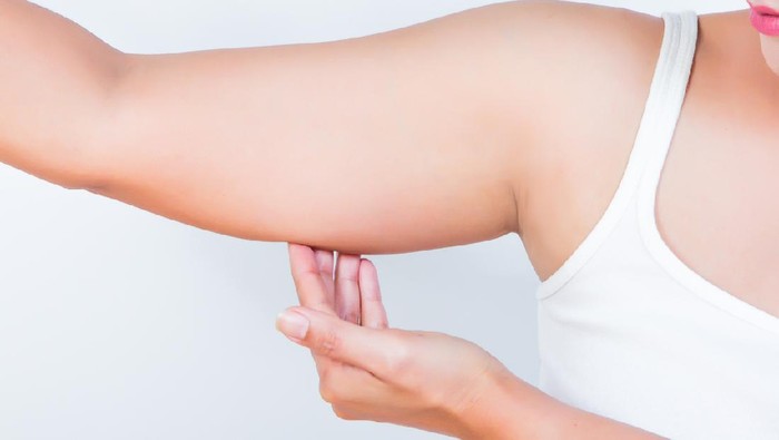 asian woman showing her fat upper arm