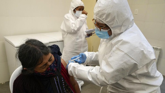 FILE - In this July 20, 2021, file photo, a healthcare worker inoculates a woman with the Sputnik V COVID-19 vaccine during a campaign vaccine for people over age 18, in La Paz, Bolivia. Millions in developing nations from Latin America to the Middle East also are waiting for more doses of Sputnik V after manufacturing woes and other issues have created huge gaps in vaccination campaigns. (AP Photo/Juan Karita, File)
