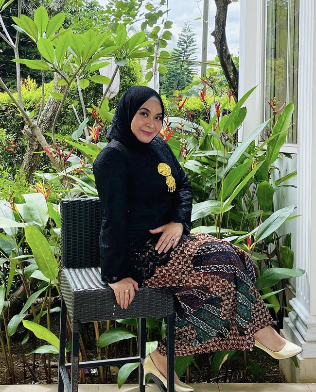 Ulfa Dwiyanti tampil anggun dan feminin saat mengenakan kebaya dan hijab plisket hitam. Dipadu dengan rok batik dan high heels.  Foto: Dok. Instagram @dwiyanthi_ulfa.