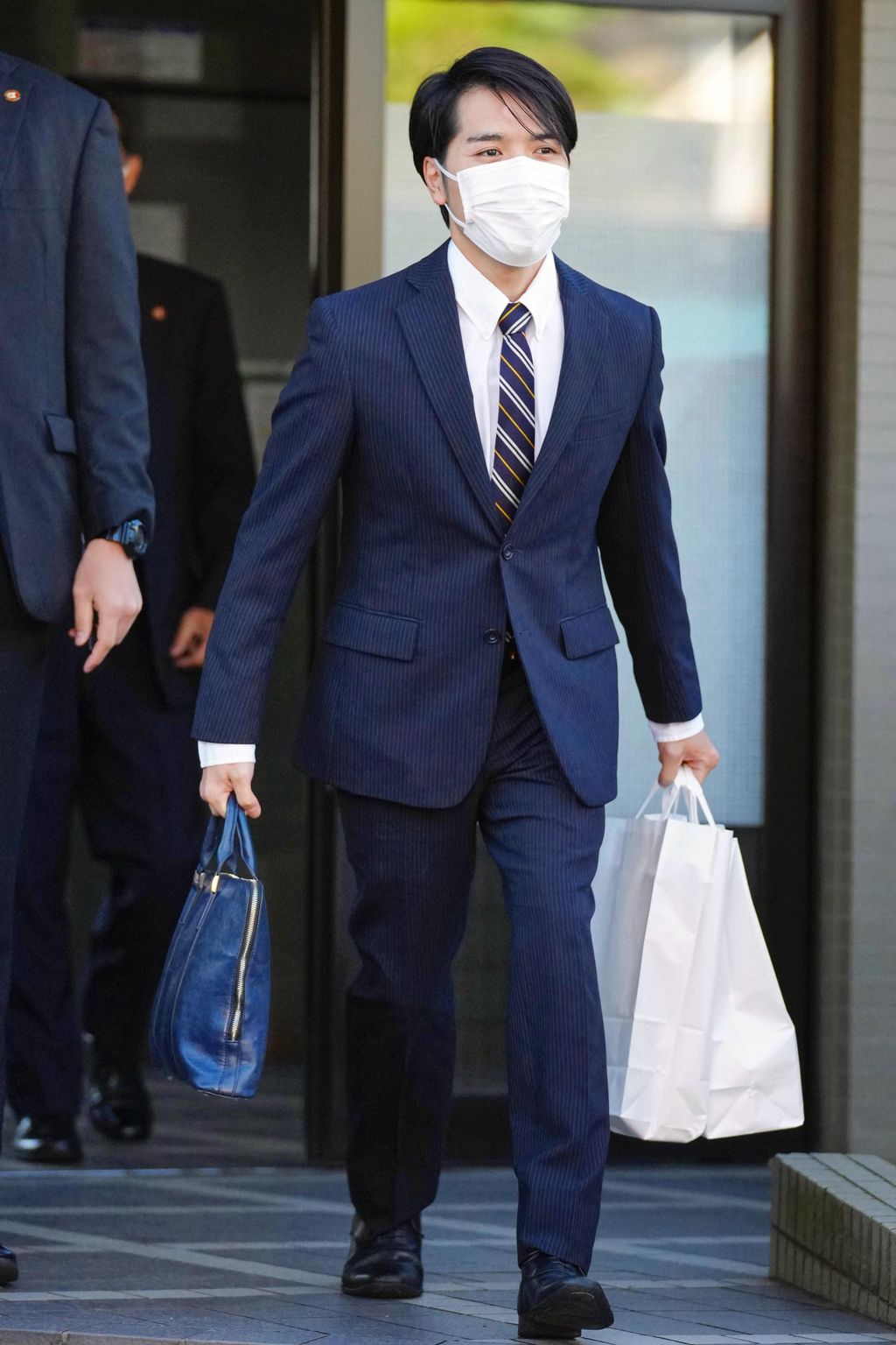 Kei Komuro, fiance of Japan's Princess Mako, leaves his family home for Akasaka Estate to meet her parents Crown Prince Akishino and Crown Princess Kiko in Yokohama, south of Tokyo, Monday, Oct. 18, 2021. Komuro, who returned to Japan from New York where he was studying to become a lawyer, and Princess Mako will get married on Oct. 26. (Kyodo News via AP)