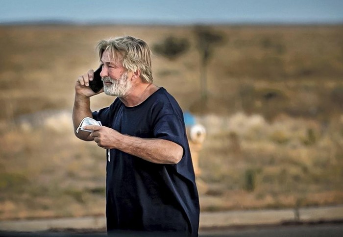 Alec Baldwin speaks on the phone in the parking lot outside the Santa Fe County Sheriffs Office in Santa Fe, N.M., after he was questioned about a shooting on the set of the film Rust on the outskirts of Santa Fe, Thursday, Oct. 21, 2021. Baldwin fired a prop gun on the set, killing cinematographer Halyna Hutchins and wounding director Joel Souza, officials said. (Jim Weber/Santa Fe New Mexican via AP)