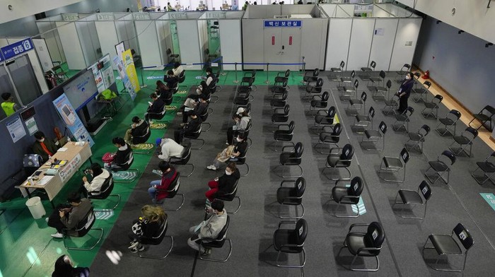 People wait to be monitored for possible side effects after receiving the Pfizer COVID-19 vaccine at a vaccination center in Seoul, South Korea, Monday, Oct. 25, 2021. (AP Photo/Ahn Young-joon)