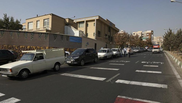 Cars wait in line to fill up at a gas station because pumps machines are out of service, in Tehran, Iran, Tuesday, Oct. 26, 2021. Gas stations across Iran on Tuesday suffered a widespread outage of a system that allows consumers to buy fuel with a government-issued card, stopping sales. One semiofficial news agency referred to the incident as a cyberattack. (AP Photo/Vahid Salemi)