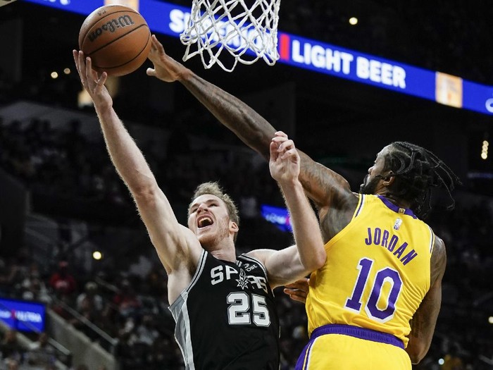 Los Angeles Lakers DeAndre Jordan (10) blocks a shot attempt by San Antonio Spurs Jakob Poeltl during the second half of an NBA basketball game on Tuesday, Oct. 26, 2021, in San Antonio, Texas. Los Angeles won 125-121 in overtime. (AP Photo/Darren Abate)