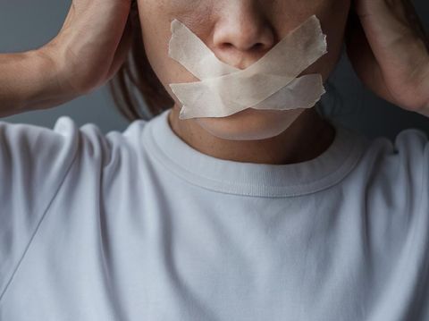 woman with mouth sealed in adhesive tape. Free of speech, freedom of press, Human rights, Protest dictatorship, democracy, liberty, equality and fraternity concepts