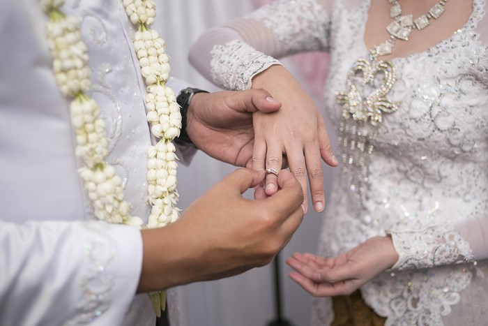 Pasang Cincin on Javanese Wedding. Traditional Javanese Groom Puts a Ring On The Bride