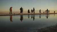 Warga berfoto di Danau Tuz yang mengering dan menyisakan sedikit air. Perubahan iklim dan kekeringan sumber air bawah tanah ditengarai menjadi salah satu penyebab danau menyusut.