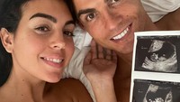 Cristiano Ronaldo sedang berbahagia saat memamerkan fotonya bersama Georgina Rodriguez sambil memegang foto USG anak kembarnya. Foto: Instagram @cristiano @georginagio