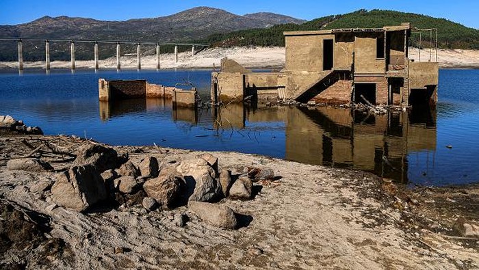 OURENSE, SPAIN - OCTOBER 27: A view of the partly submerged Aceredo village buildings as they emerge from the river Lima on October 27, 2021 in Lobios, Ourense, Spain.  The town of Aceredo has resurfaced during a low state of flow in the dam which was built 29 years ago and turned the valley into a reservoir. Some 250 people were forced to move to a village above the Lindoso reservoir and a church was moved to another town stone by stone, when the Portuguese state-owned EDP electricity company ran the Lindoso reservoir hydroelectric plant. (Photo by Octavio Passos/Getty Images)