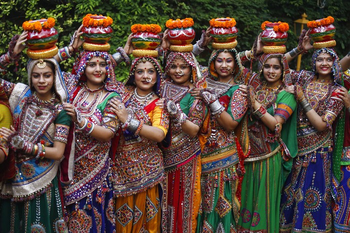 Indian women in traditional attire pose for photographs before practicing Garba, a traditional dance of Gujarat state, ahead of Hindu festival of Navratri in Ahmadabad, India, Friday, Oct. 1, 2021. The Hindu festival of Navratri or nine nights will begin from Oct. 7.  (AP Photo/Ajit Solanki)