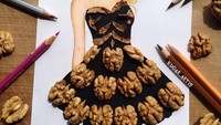 Kali ini Edgar menggunakan kacang-kacangan. Ia menggunakan walnut untuk menghiasi gambar gaun karyanya. Foto: Edgar Artist