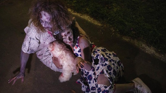A girl wears zombie make-up and outfit as she participates in the Zombie Walk 2021, part of Halloween weekend in Tel Aviv, Israel, Saturday, Oct. 30, 2021. (AP Photo/Ariel Schalit)