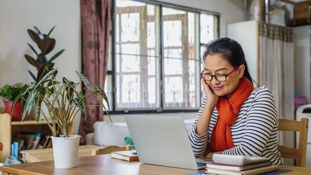 Little girl is engaged remotely with a teacher via video communication in her room