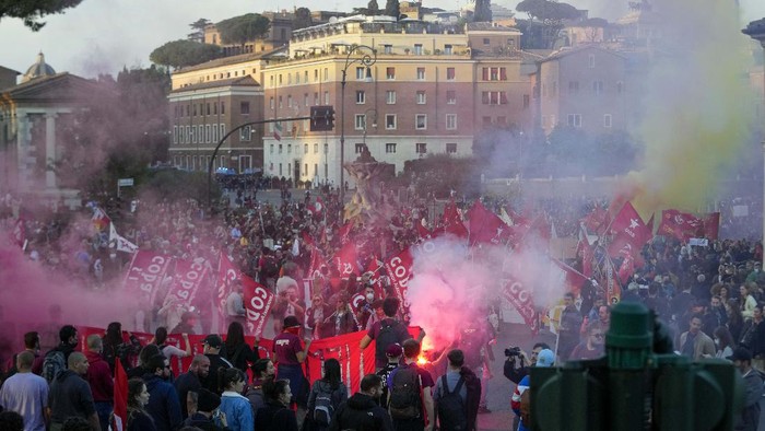 Demonstrators light flares during a march in Rome, Saturday, Oct. 30, 2021, the day a Group of 20 summit started in the Italian capital. Factory workers, climate activists, antiglobalization campaigners, unions, feminist groups, vaccine skeptics and political extremists are seizing the opportunity to voice anger while world's leaders are gathering in town for the first time in presence since the COVID-19 pandemic started in 2019. (AP Photo/Luca Bruno)