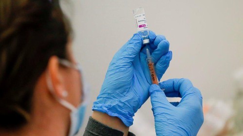 A health care worker fills a syringe with the Pfizer COVID-19 vaccine, Thursday, July 22, 2021, at the American Museum of Natural History in New York. The museum moved their vaccination site from the Hall of Ocean Life where the famous 94-foot-long model of a blue whale is hanging from the ceiling to a smaller adjacent gallery. New York City is closing the big vaccination sites to focus on areas with low vaccination rates. (AP Photo/Mary Altaffer)