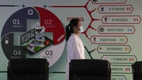 Chen Xiaofang, a nurse at the department of cardiovascular medicine the Guangdong Second Provincial General Hospital, stands next to a robot that delivers medicine in Guangzhou, in southern Chinas Guangdong province, Sunday, Sept. 26, 2021. The hospital in southern Chinas Guangdong Province is using 5G and IoT technologies to collect, transmit and monitor more data in real time, allowing healthcare workers to provide better medical service for patients. (AP Photo/Ng Han Guan)