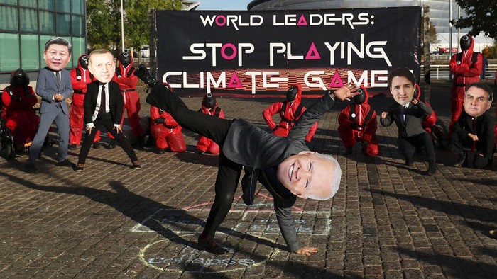 Climate campaigners wearing masks of world leaders enact a 
