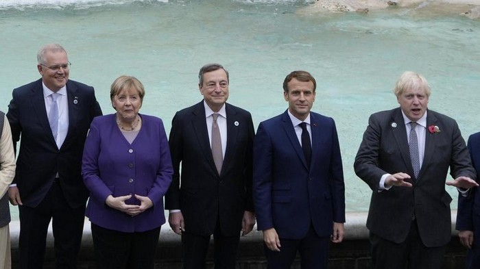 From left, Australias Prime Minister Scott Morrison, German Chancellor Angela Merkel, Italys Prime Minister Mario Draghi, French President Emmanuel Macron and British Prime Minister Boris Johnson pose in front of the Trevi Fountain during an event for the G20 summit in Rome, Sunday, Oct. 31, 2021. The two-day Group of 20 summit concludes on Sunday, the first in-person gathering of leaders of the worlds biggest economies since the COVID-19 pandemic started. (AP Photo/Gregorio Borgia)
