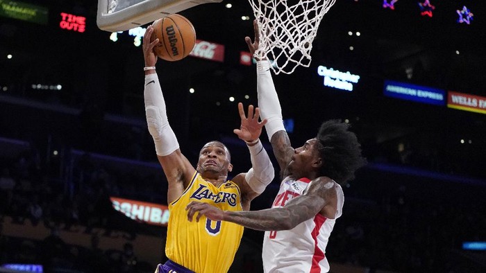 Los Angeles Lakers guard Russell Westbrook, left, drives to the basket as Houston Rockets guard Kevin Porter Jr. defends during the first half of an NBA basketball game Tuesday, Nov. 2, 2021, in Los Angeles. (AP Photo/Marcio Jose Sanchez)