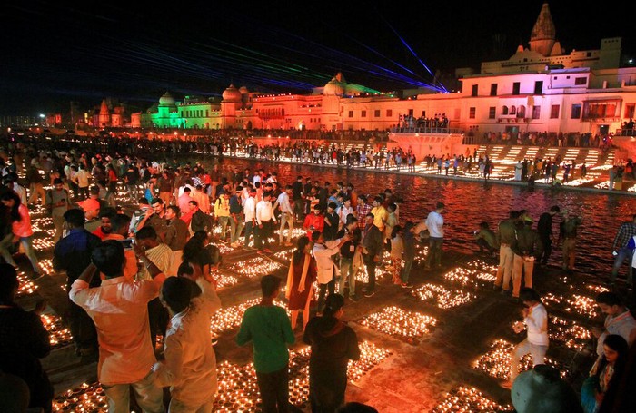 People light lamps on the banks of river Saryu in Ayodhya, India, Friday, Nov. 13, 2020. The northern Indian city of Ayodhya kept its Guinness World Record for a second straight year by lighting more than 584,572 oil lamps and keeping them burning for at least 45 minutes on the banks of the river Saryu as part of the celebration of Diwali, the annual Hindu festival of lights. (AP Photo/Rajeev Bhatt)