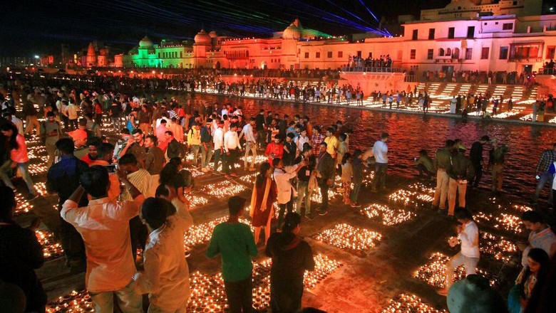 People light lamps on the banks of river Saryu in Ayodhya, India, Friday, Nov. 13, 2020. The northern Indian city of Ayodhya kept its Guinness World Record for a second straight year by lighting more than 584,572 oil lamps and keeping them burning for at least 45 minutes on the banks of the river Saryu as part of the celebration of Diwali, the annual Hindu festival of lights. (AP Photo/Rajeev Bhatt)