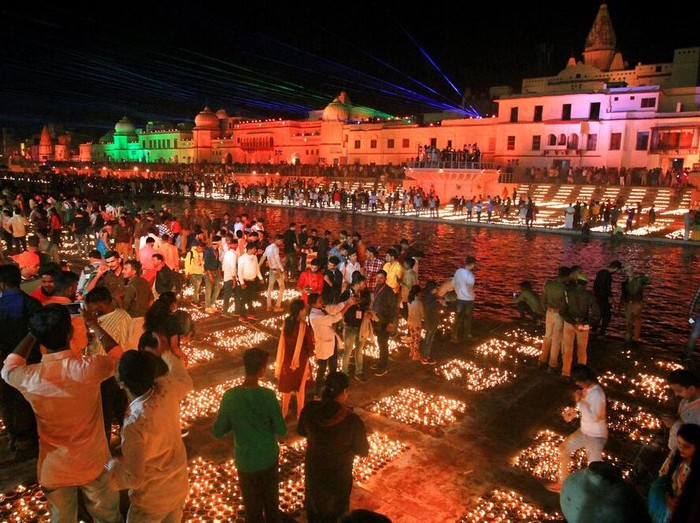 People light lamps on the banks of river Saryu in Ayodhya, India, Friday, Nov. 13, 2020. The northern Indian city of Ayodhya kept its Guinness World Record for a second straight year by lighting more than 584,572 oil lamps and keeping them burning for at least 45 minutes on the banks of the river Saryu as part of the celebration of Diwali, the annual Hindu festival of lights. (AP Photo/Rajeev Bhatt)